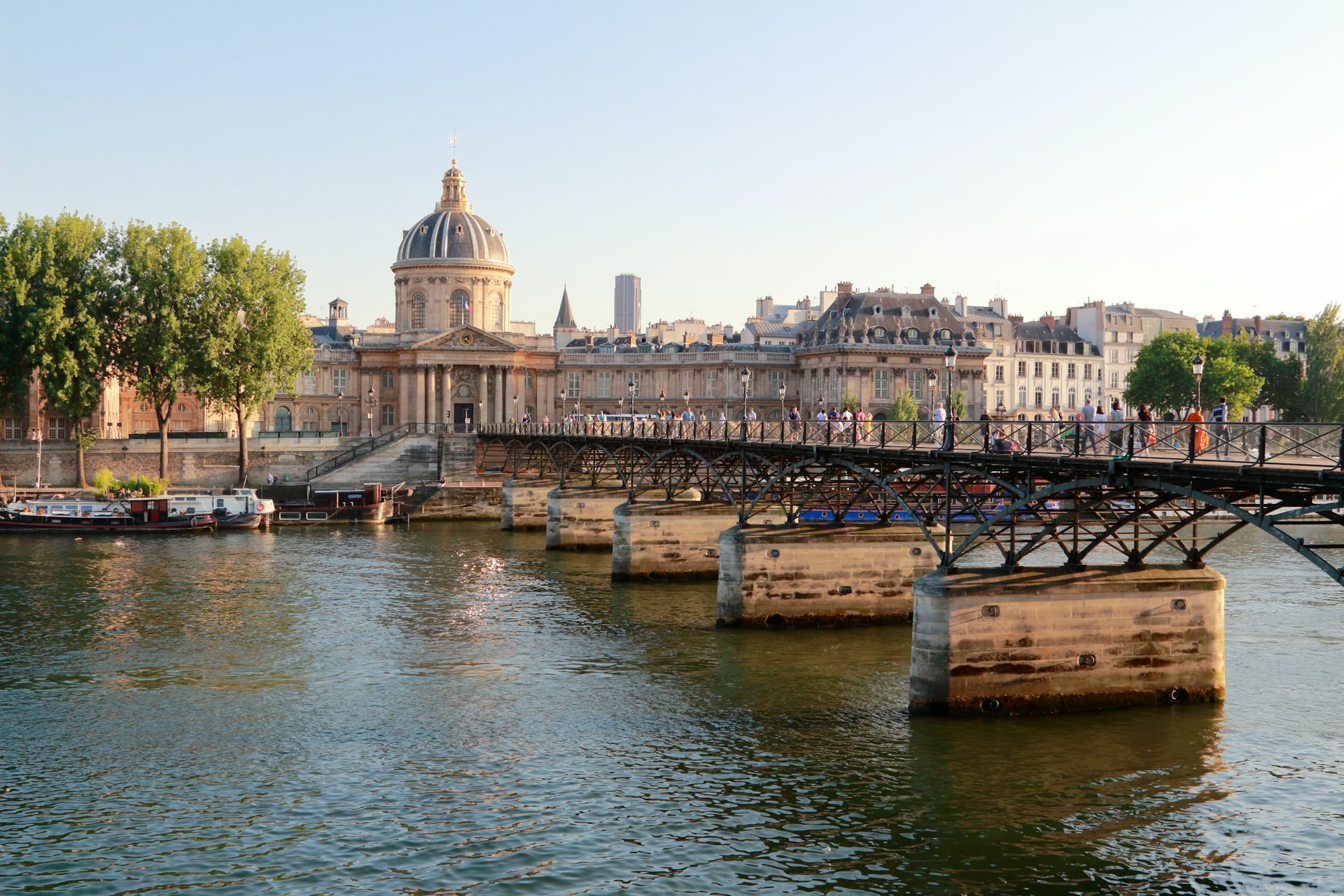 a bridge over a body of water with buildings in the background